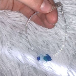 Clear seed bead anklet with blue crystals.